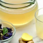 Woman preparing Brazilian Mounjaro weight loss drink in a modern kitchen with fresh ingredients on the counter. brazilian mounjaro recipe for weight loss​