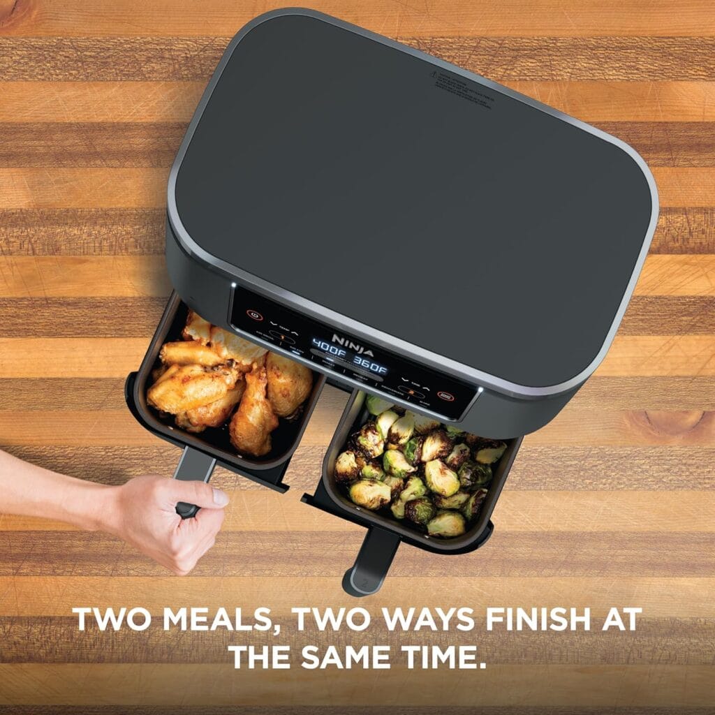  Ninja Foodi air fryer basket with crispy brussels sprouts next to a plate of wings